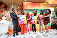 Posing with the newly designed card, (left to right) Global Network Services, South East Asia and South Pacific, American Express vice president and general manager Sanjiv Malhotra, celebrity Marsha Aruan, BNI consumer banking director Corina Leyla Karnalies, celebrity Natasha Ryder, SEVP Digital Business BNI Rian Kaslan and AMEX Indonesia director Perriz Azwir attend the launch of the BNI American Express Vibe Credit Card in Jakarta, Friday.