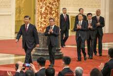  China's President Xi Jinping (left) walks with (second left to right) Li Qiang, Li Xi, Zhao Leji, Ding Xuexiang, Wang Huning and Cai Qi, members of the Chinese Communist Party's new Politburo Standing Committee, the nation's top decision-making body, as they meet the media in the Great Hall of the People in Beijing on Oct. 23.
