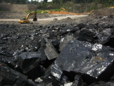 A backhoe operates on April 3, 2022 at the Binungan coal mine belonging to PT Berau Coal Energy in East Kalimantan.