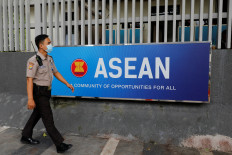 A police officer walks past a display sign for the Association of Southeast Asian Nations (ASEAN) Oct. 27, 2022 while on duty at the ASEAN Secretariat in Jakarta.
