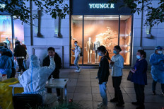 A health worker takes a swab sample from a man to test for COVID-19 in the Huangpu district of Shanghai, China, on Oct. 24, 2022.
Hector RETAMAL / AFP
