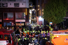Halloween’s horror: Rescue team and firefighters work at the scene where dozens of people were injured in a stampede during a Halloween festival in Seoul, on late Saturday. 