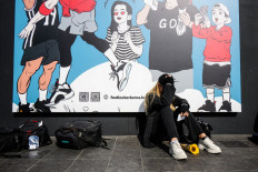 A woman cries near a makeshift memorial outside a subway station in the district of Itaewon in Seoul on October 31, 2022, two days after a deadly Halloween surge in the area. 
