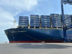 Port workers secure the CMA CGM Alexander Von Humboldt, the largest container ship to ever visit Indonesia at the Jakarta International Container Capital in Tanjung Priok, North Jakarta, on Oct. 31, 2022. The 400-meter ship has a capacity of some 16,000 twenty-foot equivalent units (TEUs).