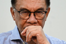Malaysian opposition leader Anwar Ibrahim pauses during a press conference ahead of the upcoming 15th general elections in Kuala Lumpur on October 13, 2022. Malaysia's prime minister dissolved parliament on October 10, 2022 to clear the way for snap elections in a bid to restore political stability as the country emerges from the ravages of COVID-19 and a multi-billion dollar corruption scandal.
