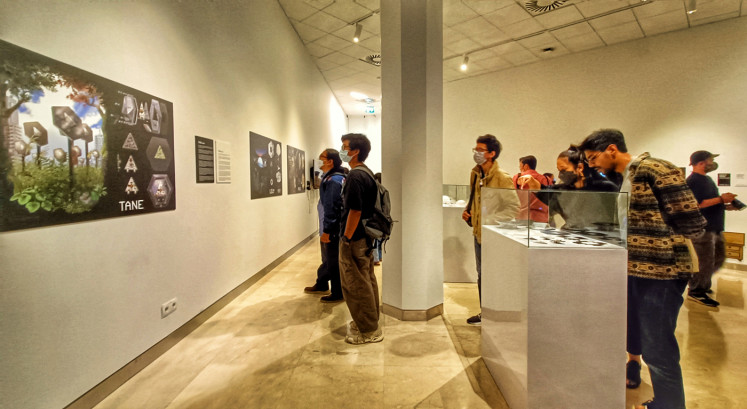 Light it up: Visitors admire the display of electrical components of 'Pixi' and 'Lili' of the 'Lumo Family' at the exhibition hall. (JP/Sylviana Hamdani)