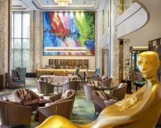 Art and design: The 'Kasmaran' golden statue (front) by Balinese artist Ketut Winata and the colorful 'Stand by Me' painting (center) by Haryanto “Bletuk“ Gunawan adorn The Lounge and lobby area, amid a luxury interior design by HBA Singapore. (Courtesy of InterContinental Pondok Indah)