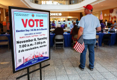 An election worker holds an American flag at a polling place at Galleria at Sunset on November 08, 2022 in Henderson, Nevada. After months of candidates campaigning, Americans are voting in the midterm elections to decide close races across the nation. 