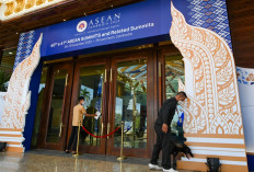 Security personnel uses a bomb sniffer dog (right) during an inspection tour of a hotel as part of security measures for the upcoming ASEAN summit in Phnom Penh on November 7, 2022. 

