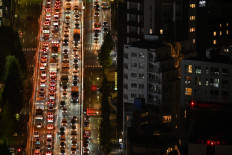 Traffic moves slowly during the evening rush hour (left lanes) making its way from Roppongi in the direction of the Shibuya area of Tokyo on Nov. 8, 2022.