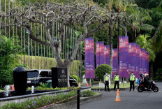 Police officers stand in front of banners of the G20 summit near a venue for the G20 Finance Ministers Meeting in Nusa Dua, Bali, on July 14, 2022. 