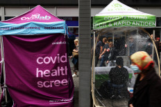 People walk by a mobile coronavirus disease (COVID-19) testing center near Port Authority bus terminal in New York City, US, on Oct. 26, 2022.