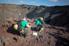 Moon-like land: German astronaut Alexander Gerst (left) collects samples of an ancient volcano during a training program to learn how to explore the Moon and Mars in the Timanfaya National Park in the Canary island of Lanzarote on Thursday.