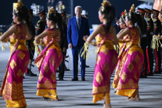 United States President Joe Biden (center) disembarks from Air Force One upon arrival at I Gusti Ngurah Rai International Airport in Denpasar, Bali, on Nov. 13, to attend the Group of 20 Summit.