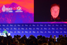 Tesla CEO and Twitter owner Elon Musk speaks virtually with Anindya Bakrie (left), chairman of the Supervisory Board of Indonesian Chamber of Commerce and Industry, at the B20 Summit as part of the G20 dialogue in Nusa Dua, Bali, on Nov. 14, 2022.