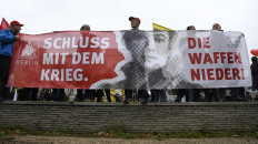 Members of the metal workers union IG Metall (IGM) Berlin hold a banner reading “End the war. Down with the weapons“ during a demonstration called by social associations, trade unions and environmental organizations in Berlin on Oct. 22, 2022.