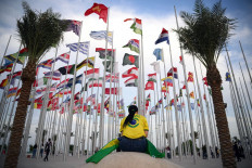 A woman sits at Flags Square in Doha on Nov. 17, 2022, ahead of the Qatar 2022 World Cup soccer tournament.