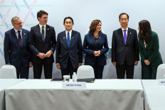 Standing together, (left to right) Australia’s Prime Minister Anthony Albanese, Canada’s Prime Minister Justin Trudeau, Japan’s Prime Minister Fumio Kishida, United States Vice President Kamala Harris, South Korea’s Prime Minister Han Duck-soo and New Zealand’s Prime Minister Jacinda Ardern pose for photos before a meeting following North Korea’s recent ballistic missile launch during the Asia-Pacific Economic Cooperation (APEC) Summit in Bangkok on Friday.