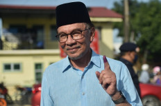 Malaysia’s opposition leader Anwar Ibrahim, chairman of the Pakatan Harapan (Alliance of Hope), shows his inked finger after voting at a polling station during the general election in Permatang Pauh, Malaysia's Penang state, on November 19, 2022. Malaysians headed to the polls on November 19 with jailed ex-leader Najib Razak's scandal-hit party seeking to cement its grip on power in a race analysts say is too close to call.