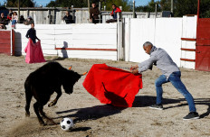 A toreador teacher of the Arles bullfighting school plays with a soccer ball during a bullfight show at the Monumental de Gimeaux arena in Arles, France, November 20, 2022.
