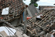 A man sifts through the rubble of a collapsed house in Cugenang, Cianjur, West Java, on Nov. 23, 2022, following a 5.6-magnitude earthquake on Nov. 21. 