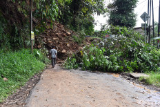 Earth and debris from an earthquake-induced landslide block a road in Cugenang, Cianjur, West Java, on Nov. 23, following a 5.6-magnitude quake that hit the area on Nov. 21.