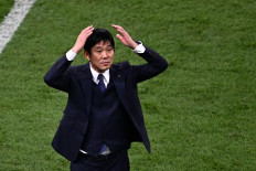 Japan's coach #00 Hajime Moriyasu celebrates his team's victory in the Qatar 2022 World Cup Group E football match between Germany and Japan at the Khalifa International Stadium in Doha on November 23, 2022. 
