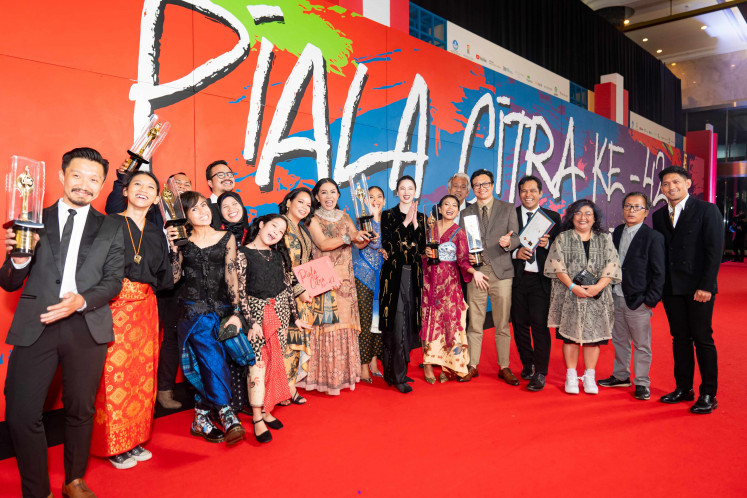 Indonesia's future: The cast and crew of 'Before, Now & Then (Nana)' take a picture together on the red carpet after winning the best feature-length film award at the 2022 Festival Film Indonesia (FFI). (Courtesy of FFI)