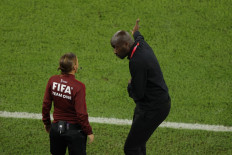 Ghana's coach Otto Addo speaks to French fourth official referee Stephanie Frappart during the Qatar 2022 World Cup Group H football match between Portugal and Ghana at Stadium 974 in Doha on November 24, 2022. 
