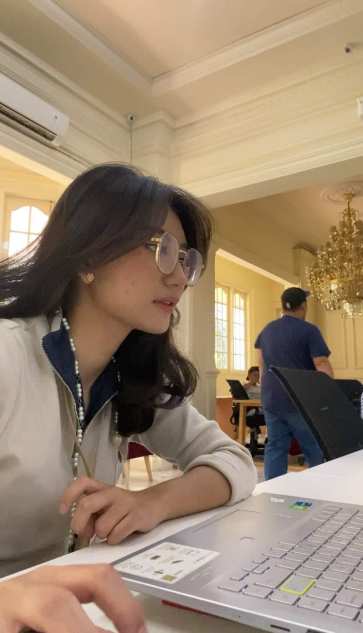 Journalistic needs: Judith Aura, pictured in October at Kumparan's head office, researches newsworthy stories, most of which are sourced from Twitter. 
