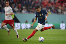 France's forward #10 Kylian Mbappe runs with the ball during the Qatar 2022 World Cup Group D football match between France and Denmark at Stadium 974 in Doha on November 26, 2022. 
