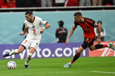 Morocco's midfielder #07 Hakim Ziyech (left) fights for the ball with Belgium's defender #21 Timothy Castagne during the Qatar 2022 World Cup Group F football match between Belgium and Morocco at the Al-Thumama Stadium in Doha on November 27, 2022. 
