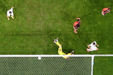 Belgium's goalkeeper #01 Thibaut Courtois (Down) concedes a goal during the Qatar 2022 World Cup Group F football match between Belgium and Morocco at the Al-Thumama Stadium in Doha on November 27, 2022. 
