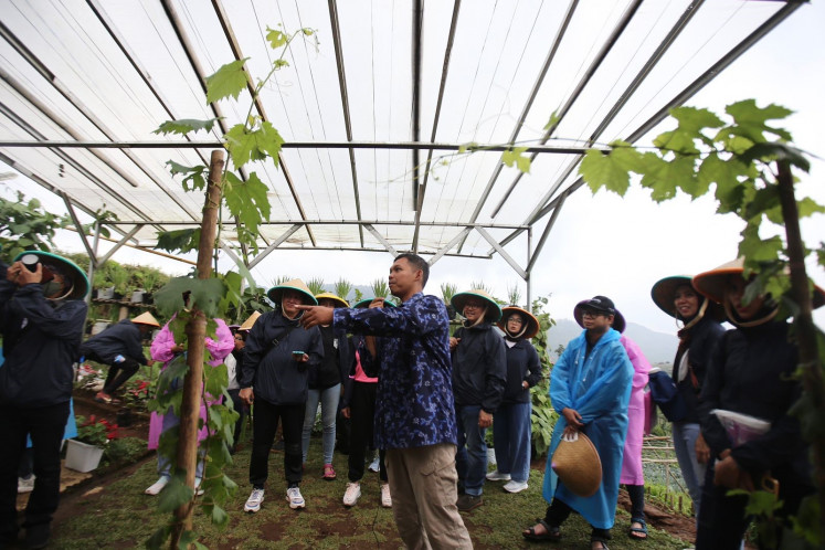 Participants of Workshop Lingkungan Astra 2022 briefed on the process of strawberry planting at KBA Suntenjaya, West Java, on Nov. 26.