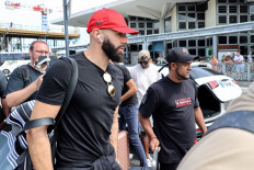 French footballer Karim Benzema (center) arrives at La Reunion's Roland-Garros airport in Sainte-Marie on November 29, 2022. Ballon D'Or winner Karim Benzema has been ruled out of the World Cup with a left thigh injury on November 19, 2022 dealing a serious blow to defending champions France's hopes of retaining the trophy.
