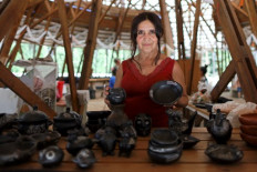 Chilean craftswoman, Esperanza Eloiza Munoz poses with her pottery pieces in Quinchamal, Chile, on November 26, 2022. The black pottery made in the Chilean villages of Quinchamalí and Santa Cruz de Cuca, whose raw material is in danger of disappearing due to logging, was recognised by the UNESCO as an Intangible Cultural Heritage in Need of Urgent Safeguarding on November 29, 2022.
