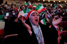 Iranian fans watch the match between their national football team and the USA during the Qatar 2022 World Cup, on a giant screen at Milad Tower in the capital Tehran, on November 29, 2022. 
