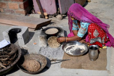 In this photograph taken on November 15, 2022, Sita Devi, a member of the Bishnoi community, cooks using cow dung at her home in Khejarli village, some 30 kms from Jodhpur in the northern Indian state of Rajasthan. The Bishnois are India's original eco-warriors, believes in the sanctity of all life, shunning meat and avoiding felling living trees. Spread mostly in hamlets across Rajasthan, the community draw inspiration from Amrita Devi, a Bishnoi woman killed in 1730 while trying to protect a khejari -- now the state tree.
