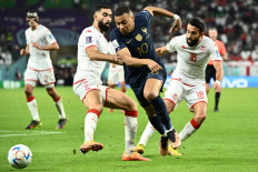 France's forward #10 Kylian Mbappe is fouled by Tunisia's defender #05 Nader Ghandri as Tunisia's midfielder #18 Ghailene Chaalali looks on during the Qatar 2022 World Cup Group D football match between Tunisia and France at the Education City Stadium in Al-Rayyan, west of Doha on November 30, 2022. 
