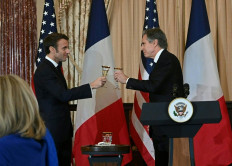 US Secretary of State Antony Blinken makes a toast with French President Emmanuel Macron during a luncheon at the US State Department in Washington, DC, on December 1, 2022. 
