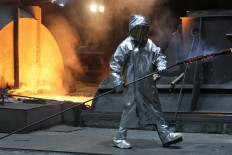 A steel worker of ThyssenKrupp walks in front of a blast furnace at a ThyssenKrupp steel factory in Duisburg, Germany, on Nov. 14, 2022.
