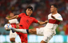 Portugal's Cristiano Ronaldo is in action with South Korea's Hwang In-beom during a match at Education City Stadium, Al Rayyan, Qatar on December 2, 2022. South Korea secures a 2-1 victory and qualifies for the World Cup 2022 knockout stages. 