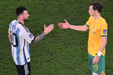 Argentina's forward #10 Lionel Messi shakes hands with Australia's midfielder #23 Craig Goodwin at the end of the Qatar 2022 World Cup round of 16 football match between Argentina and Australia at the Ahmad Bin Ali Stadium in Al-Rayyan, west of Doha on December 3, 2022. 
