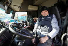 Container truck driver Kim Young-chan checks his truck at a terminal of the Inland Container Depot in Uiwang, South Korea, November 30, 2022.
