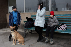 Serhii and Kataryna with their son Artem, Sheriff the dog and Barsik the cat wait for an evacuation transport, after Russia's military retreat from Kherson, at the central bus station in Kherson, Ukraine November 24, 2022.