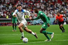 England's forward #07 Jack Grealish (left) fights for the ball with Senegal's defender #02 Formose Mendy during the Qatar 2022 World Cup round of 16 football match between England and Senegal at the Al-Bayt Stadium in Al Khor, north of Doha on December 4, 2022. 
