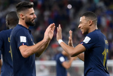 France's forward #10 Kylian Mbappe (right) celebrates scoring his team's second goal with France's forward #09 Olivier Giroud during the Qatar 2022 World Cup round of 16 football match between France and Poland at the Al-Thumama Stadium in Doha on December 4, 2022. 
