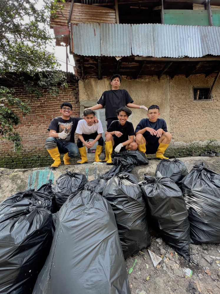 One trash bag at a time: The Pandawa Group smiles over their accomplishment. Since they began cleaning rivers in August, they have collected 2,800 bags of trash. (Courtesy of Pandawara Group)