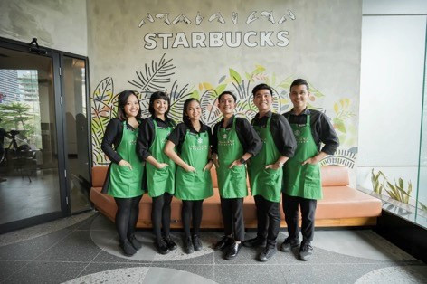 Employees of Indonesia’s first Starbucks Signing Store pose for a group photograph.