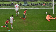 Switzerland's goalkeeper #01 Yann Sommer and teammates react next to Portugal's players celebrating following Portugal's third goal scored by Portugal's forward #26 Goncalo Ramos during the Qatar 2022 World Cup round of 16 football match between Portugal and Switzerland at Lusail Stadium in Lusail, north of Doha on December 6, 2022.